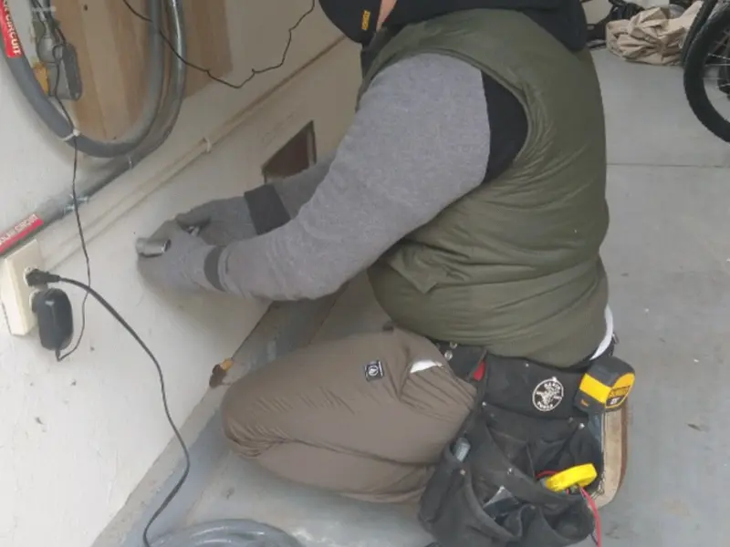 Electrician performing outlet wiring in a North Fair Oaks garage
